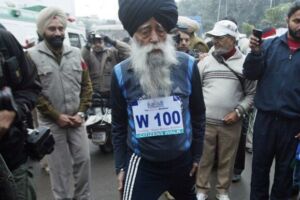 Fauja Singh, meta kien diġa' kellu 100 sena, jagħmel il-warm-up qabel il-bidu ta' maratona fl-Indja, fl-2012.